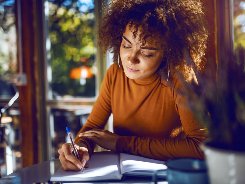 woman writing in notebook
