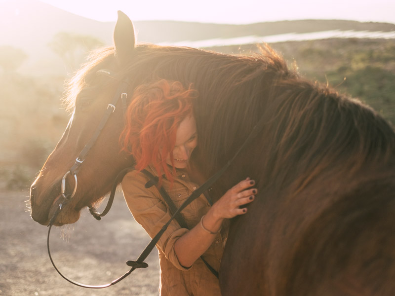 woman hugging horse