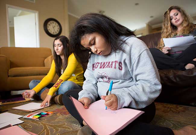Teen girls studying at home